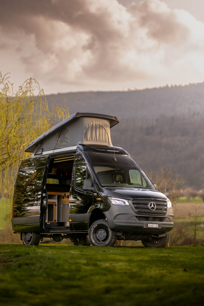 Individuell ausgebauter Camper Van von BiwakLab mit Aufstelldach, Offroad Bereifung und hochwertigem Innenausbau in der Natur in der Schweiz